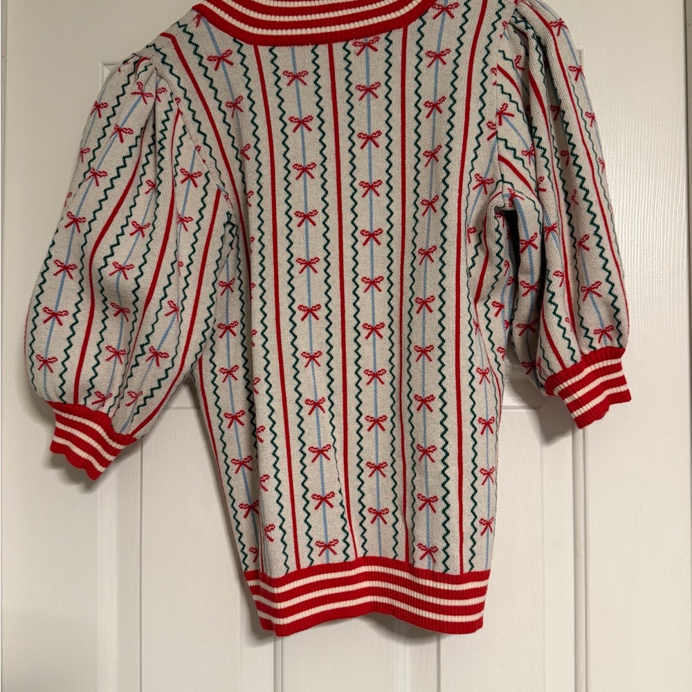 Cream V‑Neck Puff Sleeve Sweater with Red Bows and Green Stripe Detailing